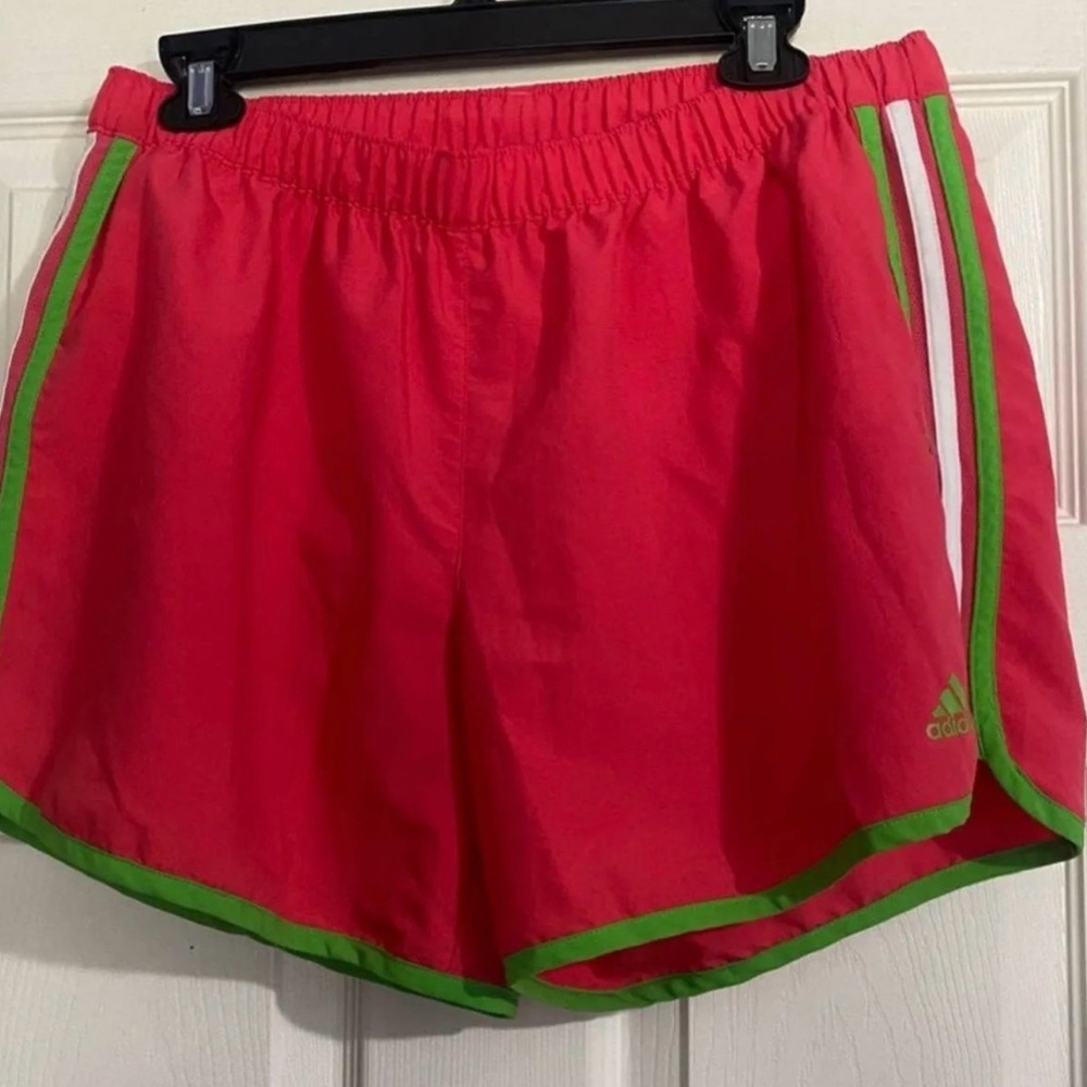 Adidas Women's Vibrant Red Athletic Shorts with Green Trim are a size Large.